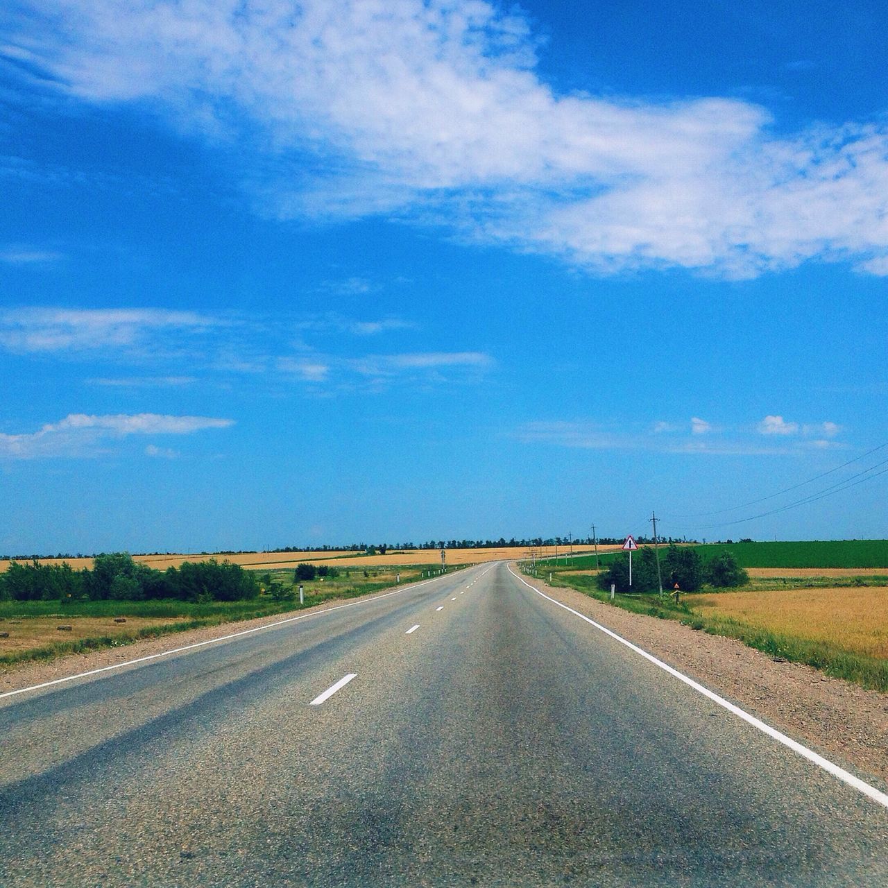 the way forward, road, transportation, diminishing perspective, vanishing point, road marking, sky, country road, landscape, empty, empty road, asphalt, cloud - sky, blue, tranquil scene, long, tranquility, cloud, field, street