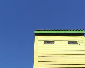 Low angle view of building against clear blue sky