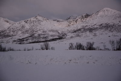 Scenic view of snow covered mountains against sky
