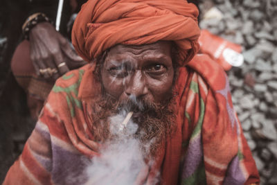Close-up portrait of a man , smoking.