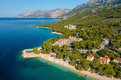 Aerial view of brela town below biokovo mountain, the adriatic sea, croatia