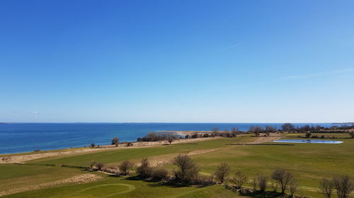 Scenic view of sea against clear blue sky