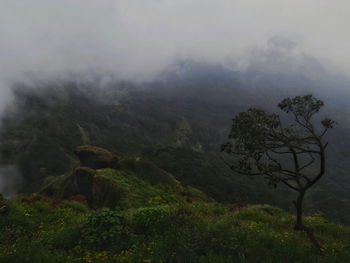 Scenic view of mountains against sky during foggy weather