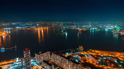 Aerial view of illuminated modern buildings in city at night