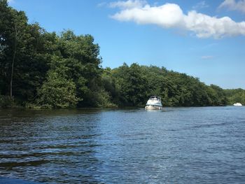 Boat sailing in river against sky