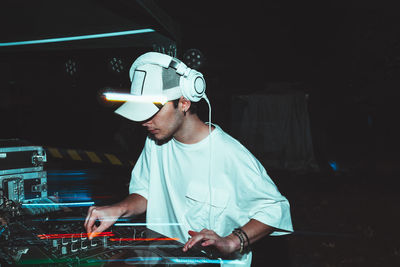 Dj mixes the track in the nightclub at party