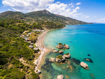 High angle view of sea and mountains against sky