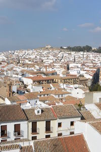 High angle view of houses in town against sky