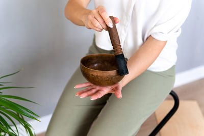 Person using tibetan singing bowl