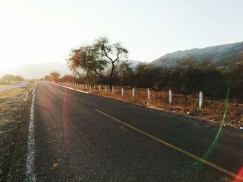 Road by mountain against clear sky