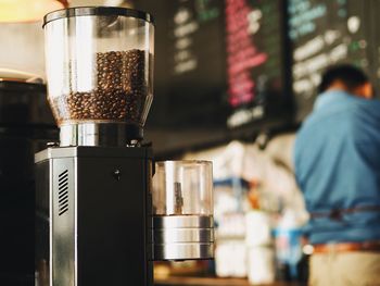 Coffee beans in espresso maker at cafe