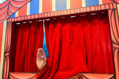 Red umbrella against curtain