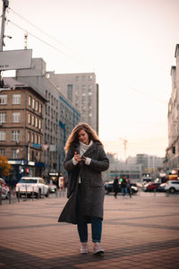 Woman standing on street in city