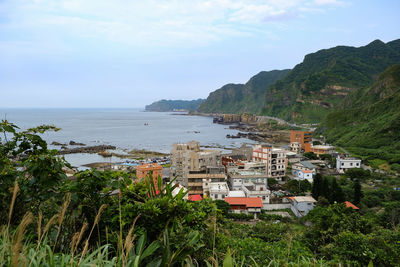Scenic view of sea and buildings against sky