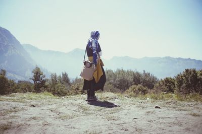Full length of man standing on street against sky