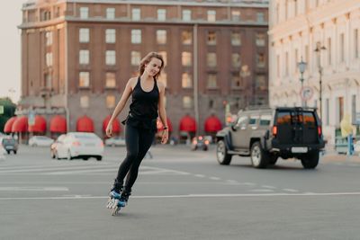 Full length of woman on street in city