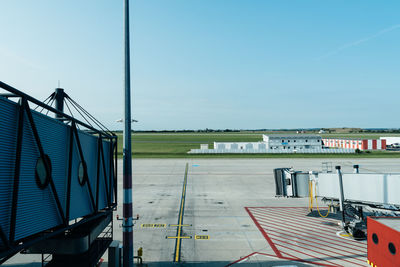 Airplane on airport runway against clear blue sky