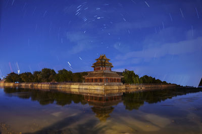 Scenic view of lake against sky at night