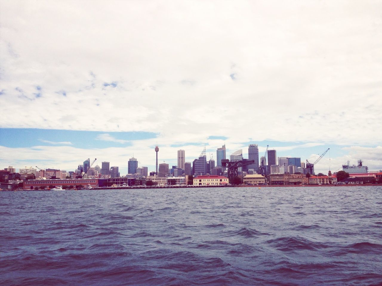 waterfront, building exterior, water, architecture, built structure, city, sky, sea, cityscape, river, rippled, cloud - sky, urban skyline, skyscraper, cloud, nature, mid distance, residential building, day, outdoors