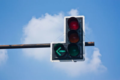 Low angle view of road sign against sky