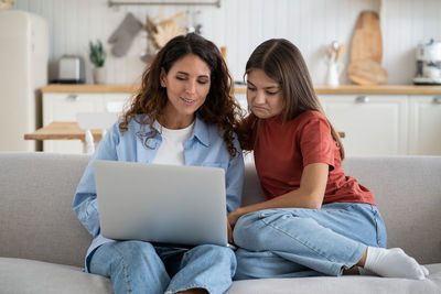 Young woman using laptop at home