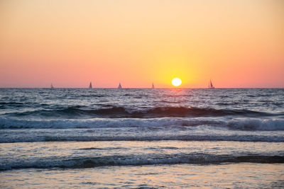 Scenic view of sea against clear sky during sunset