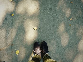 Low section of person standing on road