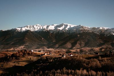 Scenic view of snowcapped mountains against clear sky