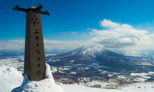 Scenic view of snowcapped mountains against blue sky
