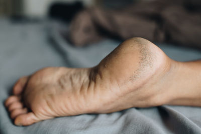 Close-up of man lying on bed