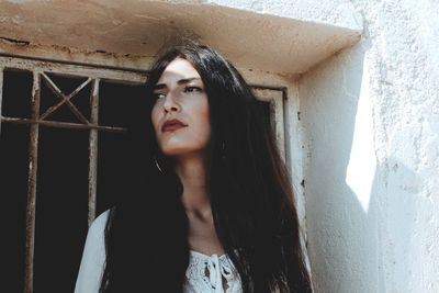 Portrait of beautiful young woman looking away