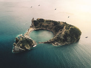 High angle view of rocks on sea shore