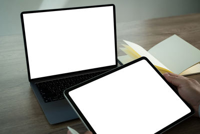 High angle view of laptop and digital tablet on table