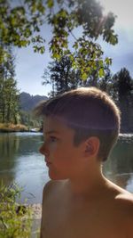 Portrait of boy looking away in lake