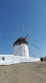 Traditional windmill against clear blue sky