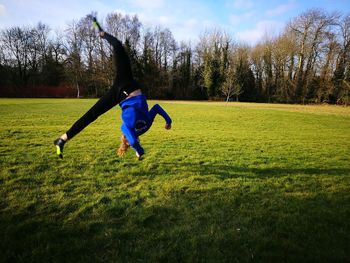 Full length of boy jumping on grass