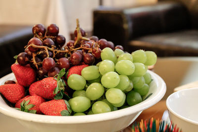 Close-up of grapes in plate on table