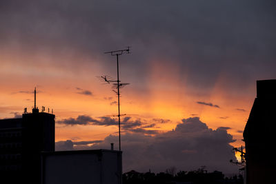 Low angle view of silhouette buildings against sky during sunset