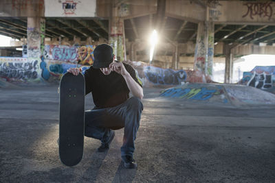 Man sitting in abandoned building