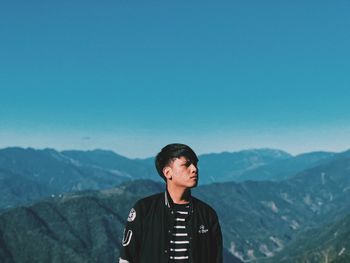 Man standing on mountain against clear sky