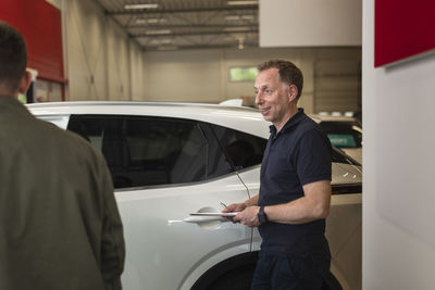 Men in car dealership office