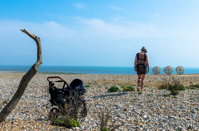 Rear view of people on land against sky
