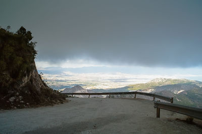 Scenic view of mountains against cloudy sky