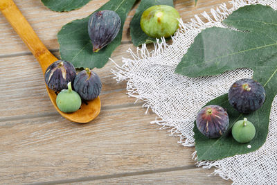 High angle view of fruits and leaves on table