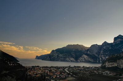 Scenic view of sea and mountains against sky