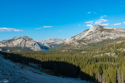 Scenic view of snowcapped mountains against blue sky