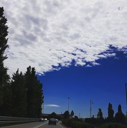 Cars on road against sky