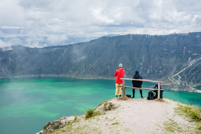 Man standing on mountain against sky