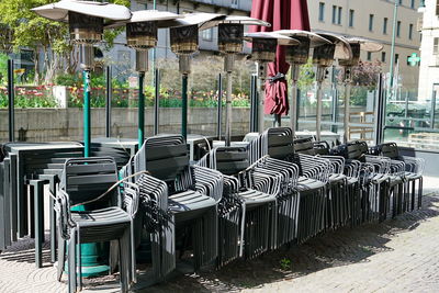 Chairs in row against buildings in city
