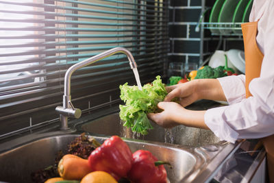 Cropped image of person preparing food at home